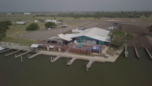 Aerial view of waterfront building and docks.