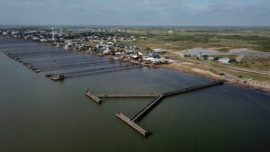 Aerial view of coastal town and piers.