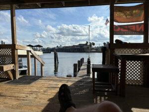 Dockside view with pier and cloudy sky.